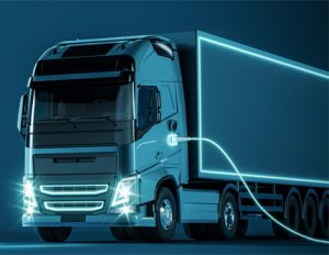 Blue electric truck connected to charger on blue background with